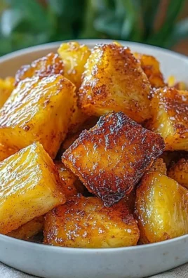 Air fryer pineapple chunks served on a plate, ready to enjoy as a healthy snack.