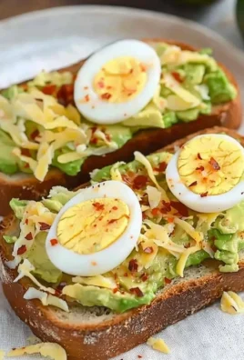 Avocado toast topped with a perfectly cooked egg.