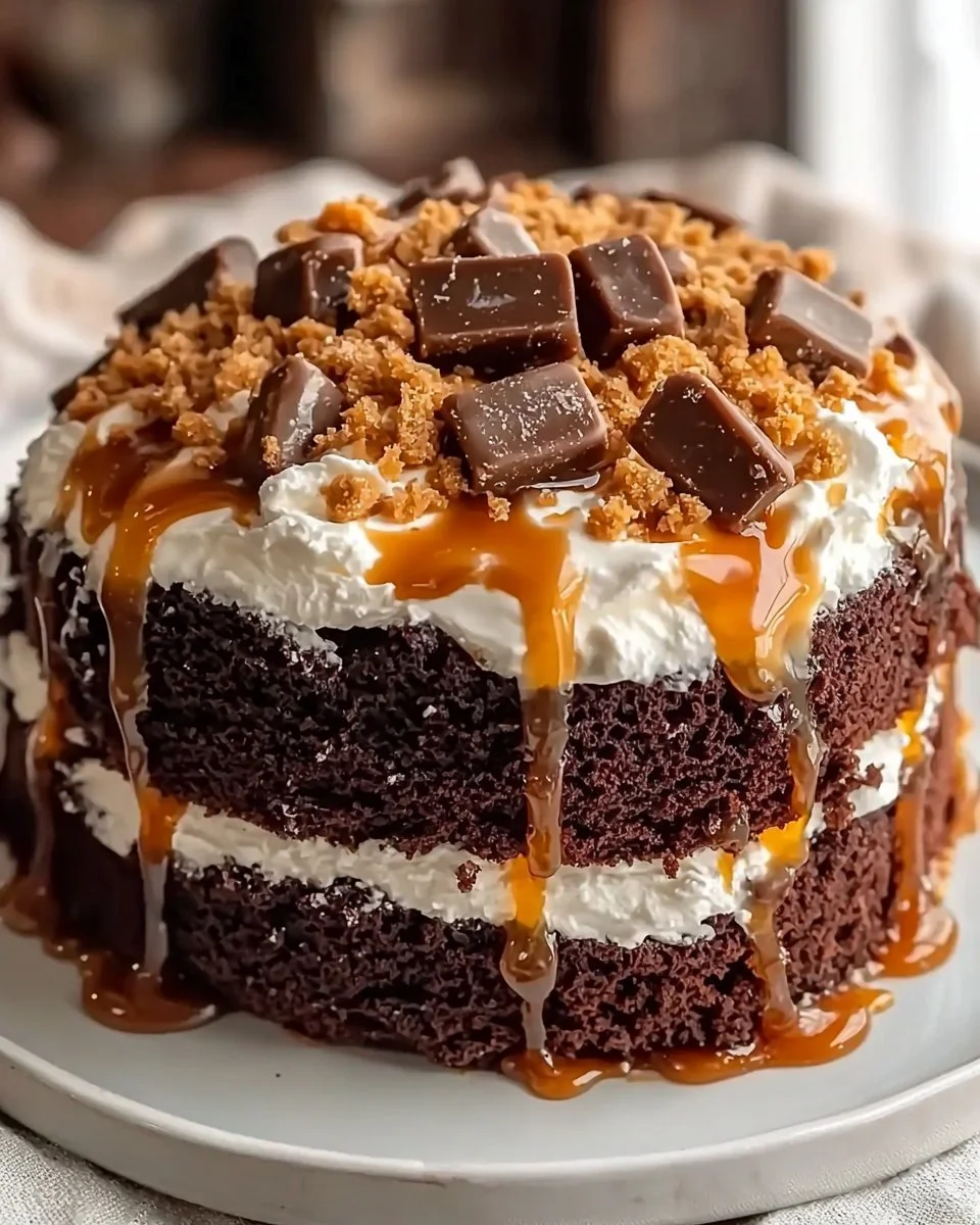 Delicious Better Than Sex Cake freshly baked and topped with chocolate and whipped cream.
