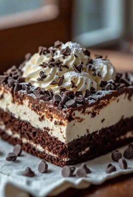 Delicious Brownie Refrigerator Cake layered with creamy frosting and toppings.