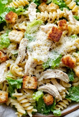 Delicious Chicken Caesar Pasta Salad served in a bowl with fresh ingredients and dressing.
