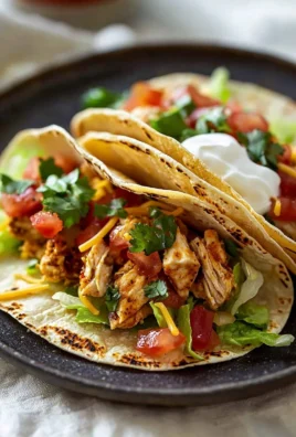 Delicious chicken tacos topped with fresh vegetables and sauces