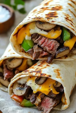 Delicious crispy Philly cheesesteak grilled wraps on a plate