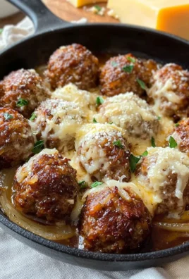 Plate of savory French onion meatballs topped with melted cheese
