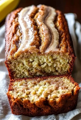 Slice of homemade cinnamon swirl banana bread with a golden crust.