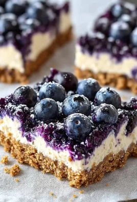 No-bake blueberry cheesecake bars topped with fresh blueberries.