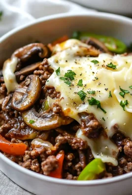 Philly Cheesesteak Bowl with peppers, onions, and steak on a plate.