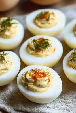 Pickle Lover Deviled Eggs topped with pickles and spices on a serving platter