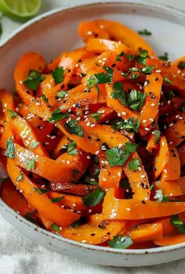 Fresh raw carrot salad with herbs and dressing on a plate