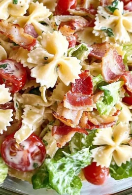 A colorful bowl of BLT Pasta Salad with bacon, lettuce, and tomato.