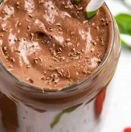 Chocolate Raspberry Smoothie with Avocado in a glass topped with fresh raspberries