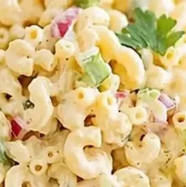 Classic macaroni salad served in a bowl at a summer picnic