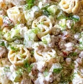 Delicious cold pasta salad with colorful vegetables and dressing