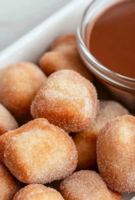 Crispy air fryer churro bites served on a plate with cinnamon sugar