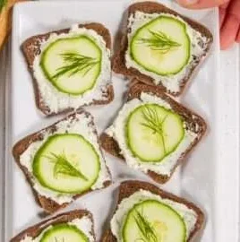 Delicious homemade cucumber sandwiches ready to be served on a platter.