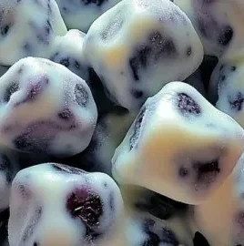 Frozen yogurt dipped blueberries arranged on a plate for a healthy snack