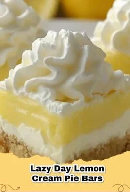 Easy Lemon Cream Pie Bars topped with fresh lemon slices and whipped cream
