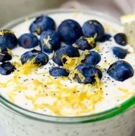Bowl of Easy Lemon Poppy Seed Overnight Oats with lemon slices and poppy seeds