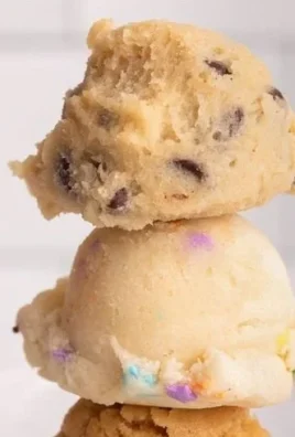 Bowl of edible chocolate chip cookie dough with chocolate chips on top
