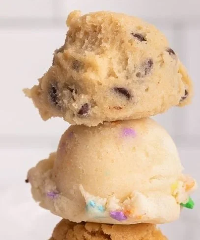 Bowl of edible chocolate chip cookie dough with chocolate chips on top