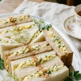 Delicious egg salad tea sandwiches served on a platter for afternoon tea