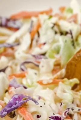 Gordon Ramsay's crunchy coleslaw served in a bowl with fresh ingredients.