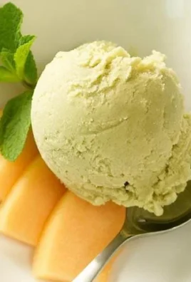 A bowl of homemade avocado ice cream topped with mint leaves.