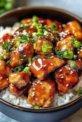 Delicious Hot Honey Chicken Bowl topped with fresh ingredients and drizzled with honey