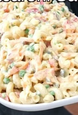 Delicious macaroni salad served in a bowl with colorful vegetables