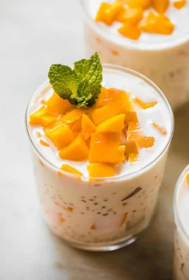 Delicious Mango Sago dessert topped with fresh mango and coconut cream.