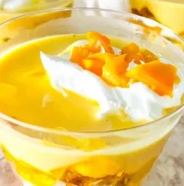 Delicious Mango Trifle Cups with layers of mango, cream, and cake.