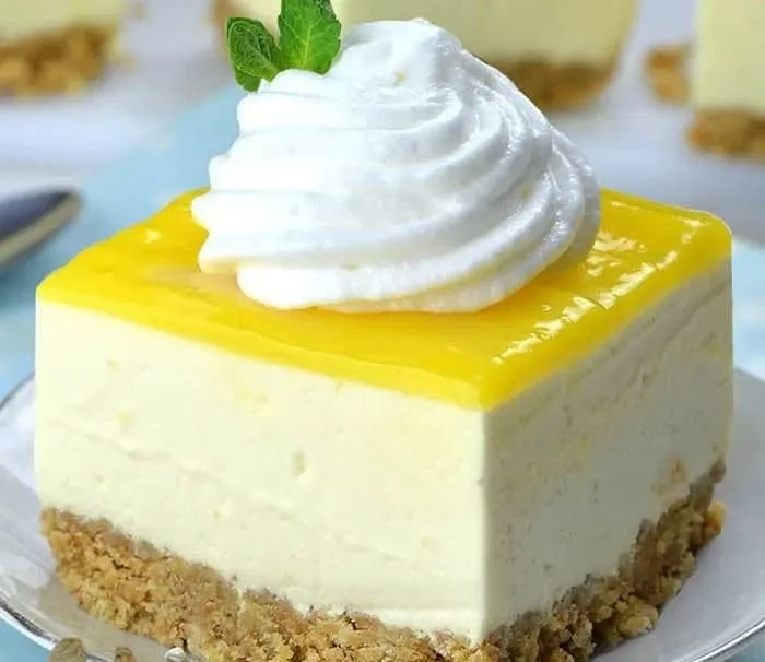 No Bake Lemon Cheesecake Bars with a creamy lemon topping and graham cracker crust.