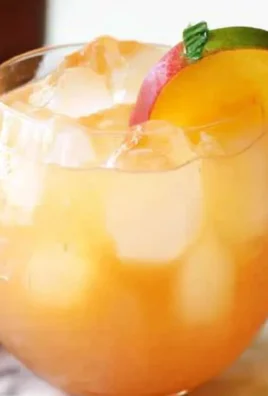 Refreshing Peach Moscow Mule cocktail served in a copper mug.