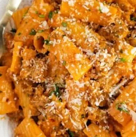 Delicious serving of spicy sausage rigatoni topped with herbs