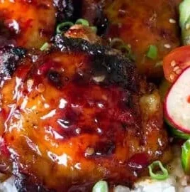 Sticky sweet chili chicken thighs cooked in an air fryer, garnished and ready to serve.