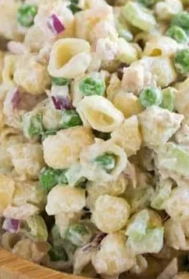Delicious Tuna Pasta Salad served in a bowl with fresh vegetables.