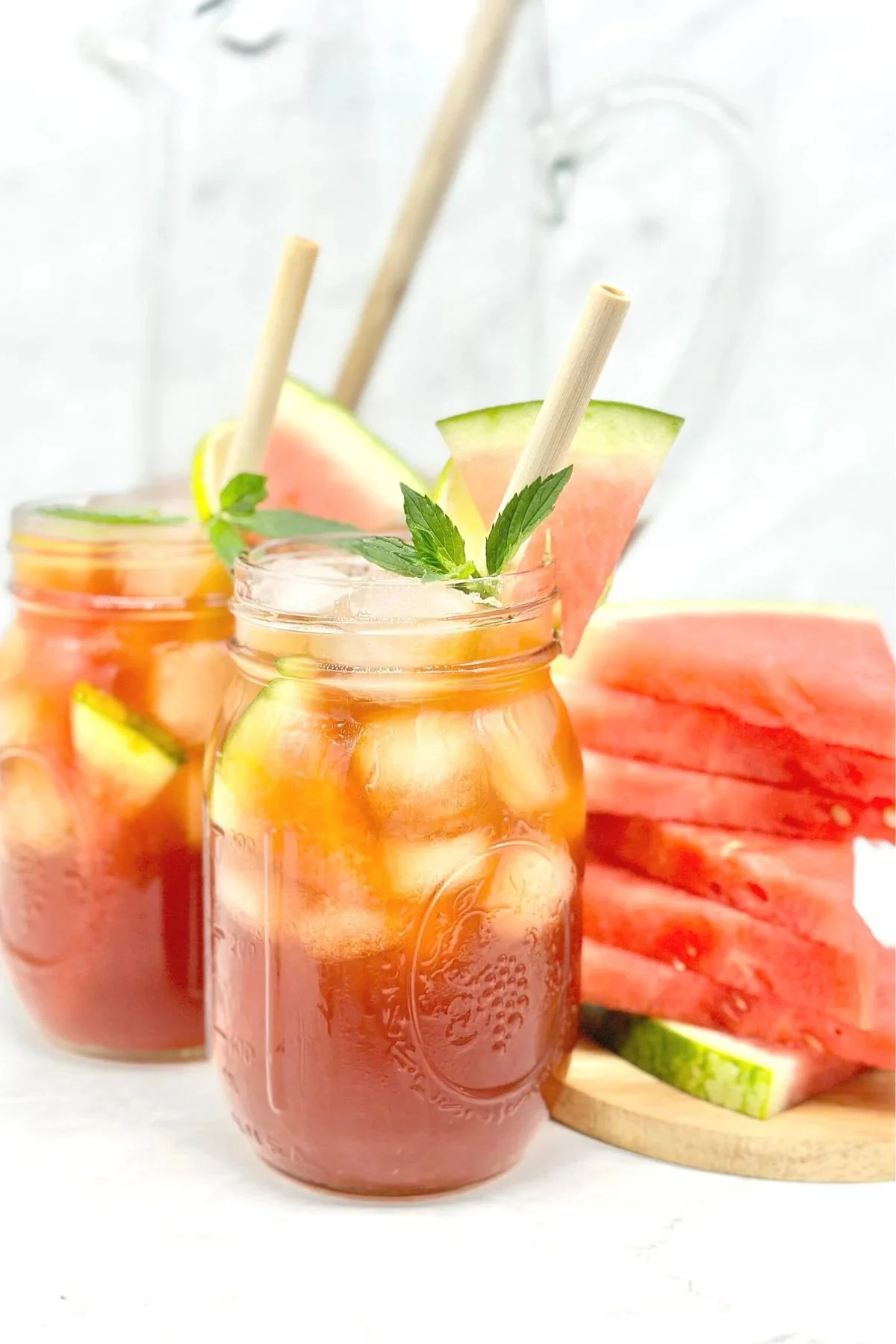 Refreshing watermelon iced tea in a glass with mint leaves.
