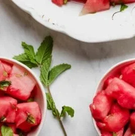 Refreshing watermelon slices with lime and mint garnish.