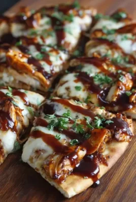 BBQ chicken flatbread topped with fresh ingredients and drizzled with sauce
