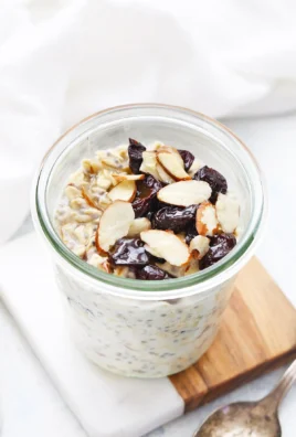 Bowl of Cherry Almond Overnight Oats topped with fresh cherries and almonds.