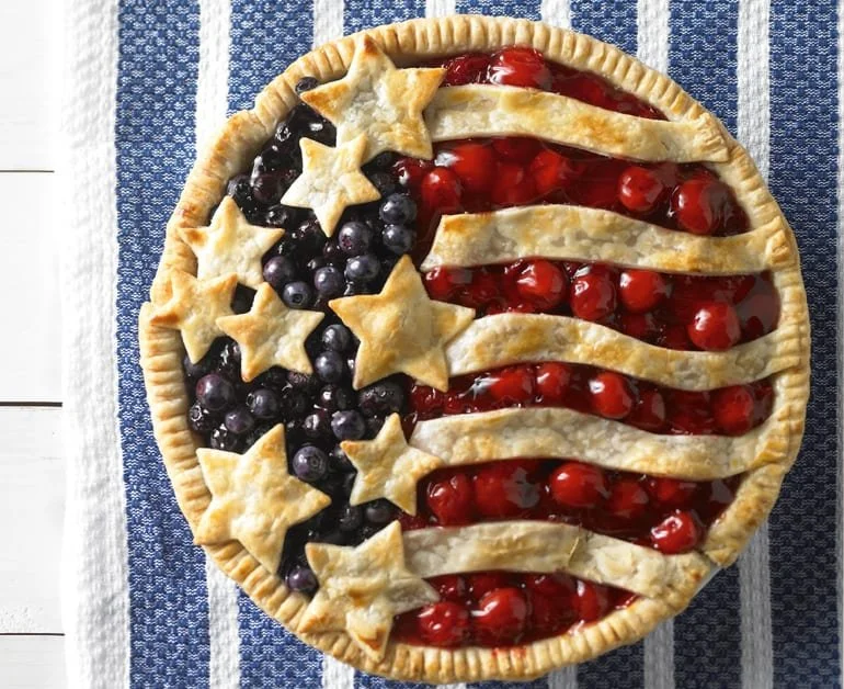 Homemade Cherry Blueberry Pie with fresh fruits on a rustic wooden table