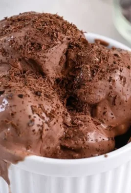 A bowl of chocolate cottage cheese ice cream topped with chocolate shavings.