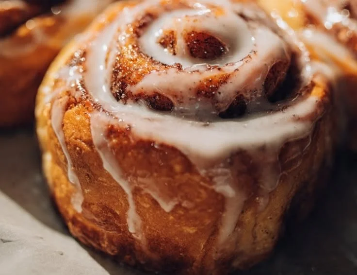 Delicious cinnamon roll glaze bombs with a creamy glaze on top