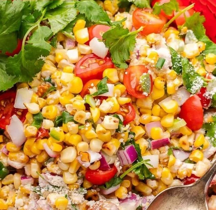 Creamy elote corn salad with corn, chili, and cheese in a bowl