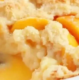 Delicious easy peach cobbler served warm with ice cream