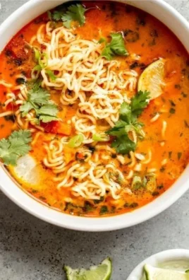 Bowl of delicious Easy Thai Noodle Soup with fresh herbs and lime.