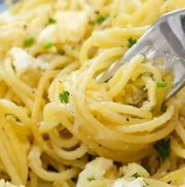 Plate of fried spaghetti served with fluffy scrambled eggs