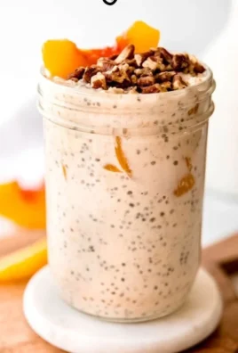 High protein peach overnight oats in a bowl with fresh peaches and oats
