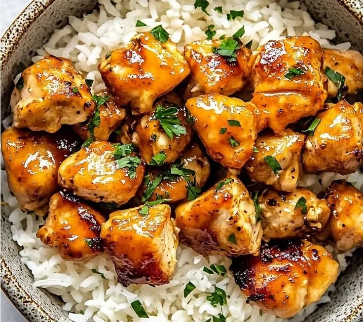 Delicious hot honey chicken bowls garnished with fresh vegetables.