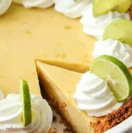 Delicious slice of homemade Key Lime Pie with whipped cream and lime garnish